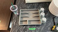 Top view showing utensil organizer, Starbucks cup, three spice jars