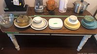 Entire lot on table showing all dish stacks, mixing bowls and casserole