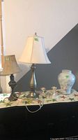 Group view of both lamps, vase, candlesticks and table runner
