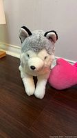 Gray and white husky plush standing upright on floor