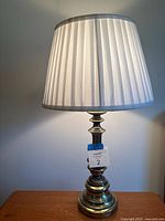 Full view of brass lamp with shade