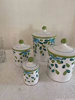 Four stoneware canisters with lids, floral motif