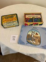 Overview of all three items: Crayola tin, Melissa & Doug alphabet box, Navajo String Games booklet