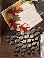 Autumn leaf print napkin with group of silver-tone napkin rings