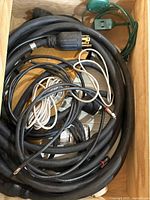 Drawer with heavy-duty extension cord, assorted cables, green outlet adapter