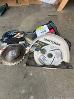 Circular saw with loose and packaged blades on floor