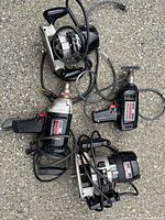Group shot of two drills and two routers with cords