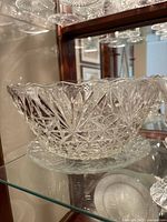 Large cut-glass punch bowl on matching plate