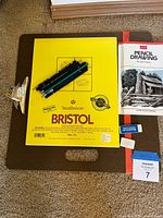 Overall lot showing board, pad, pencils, booklet, erasers