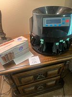 Coin sorter and box of wrappers on table