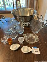 Group shot showing punch bowl, four pitchers, juicer, egg cups and lidded jar