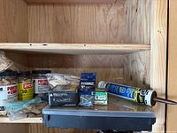 Overall view showing jars of biscuits, screw organizer, boxes of screws, and caulk tube