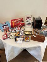 Overview showing Yahtzee, Wine Wars, card decks, domino set, cribbage, shuffler