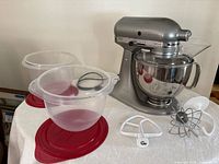 Mixer with all accessories and bowl liners displayed