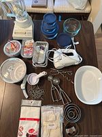 Overall view of appliances, bakeware and utensils on table