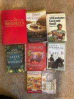 Eight books laid out front covers visible