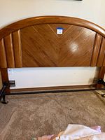 Oak queen headboard front view with attached metal frame