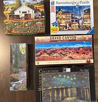 Five puzzle boxes displayed together