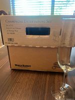 Closed World Market Champagne Entertaining Set box with flute beside