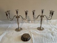 Pair of candelabra and stacked coasters shown together