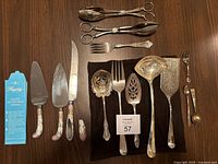 Overall lot layout showing all silverplate pieces and Hagerty strips