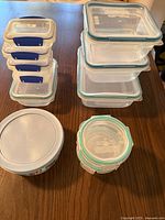 Stacked view showing Snapware rectangular and square containers, Pyrex bowl, and round Snapware pieces