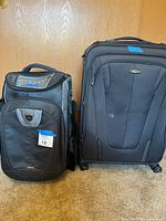 Front view of both suitcases showing overall style and size comparison