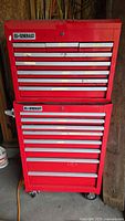 Front view of stacked red US General Pro tool chests showing drawers and casters