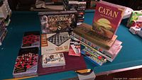 Overall lot showing multiple boxed games on pool table