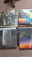 Four LPs including ELO, Dan Hill, Supertramp and unidentified seated-man cover