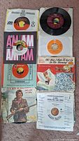 Mixed 45 RPM singles showing various company and picture sleeves