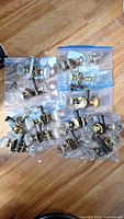 All bagged sets of glass door knobs laid out on floor