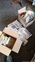 Two boxes filled with paper sewing patterns