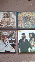 Four LP jackets: Emmylou Harris "Cimarron", Elton John "Captain Fantastic", Elton John "Greatest Hits", Seals & Crofts "Greatest Hits"
