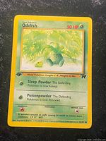 Front of Oddish card displaying artwork, stats, 1st edition stamp, expansion symbol, set number 63/82