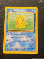 Front of Psyduck Team Rocket card showing artwork, 1st Edition stamp, stats and card number 65/82