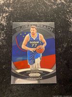 Front of Luka Doncic Global Reach Prizm card showing player image, flag background and set branding