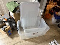 Both clear storage bins with lids stacked together