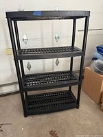 Full view of black 4-shelf plastic unit