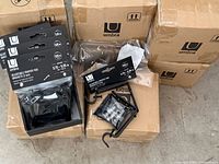 Multiple sealed retail packs and outer shipping cartons showing Umbra branding