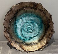 Top view of the glass bowl showing bronze rim and turquoise interior spiral