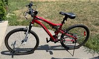 Full left-side view of red CCM 24-inch mountain bike