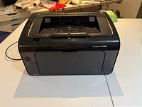 Front view of HP LaserJet P1102w printer, closed tray