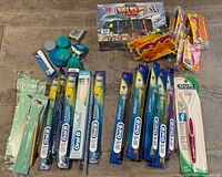 Entire lot laid out showing toothbrushes, flossers, cleaners