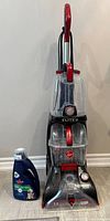Full view of Hoover PowerScrub Elite carpet cleaner with shampoo bottle