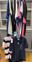Rack showing multiple polos in assorted colours and stripes