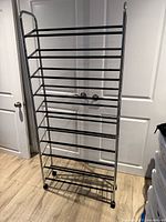 Full view of chrome rolling shoe tower showing height, tiers, casters