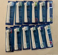 Front view of all 12 individually packaged brush heads