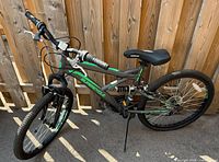 Right side view of full Supercycle bicycle showing frame, wheels, suspension, saddle, and graphics