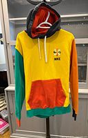 Front view of Nike multicolor hoodie showing color-block design, pocket and front logo
